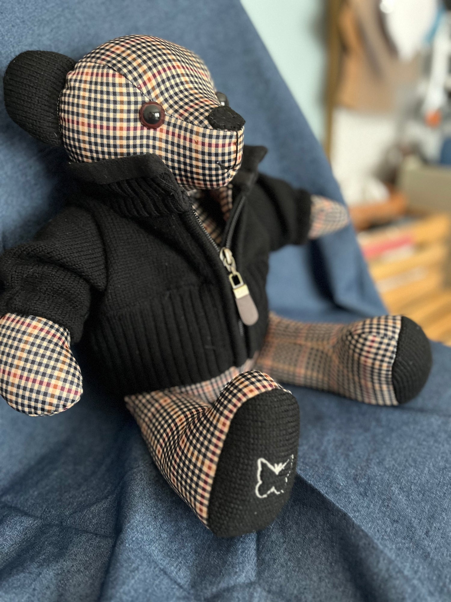Teddy Bear made from clothes. Bear is blue and plaid with blue vest.