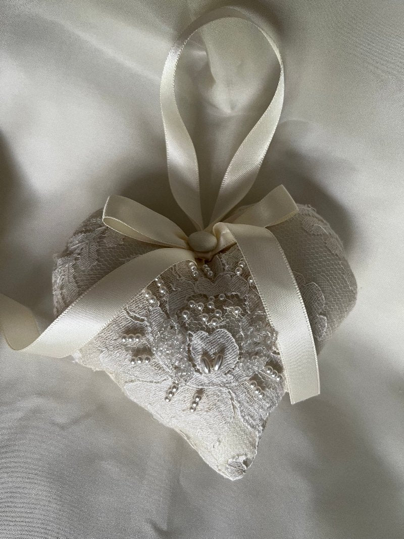 One ivory 4x4 heart-shaped wedding ornament with  embroidered lace  and beads made from repurposed wedding gown.  It has a beige ribbon  with a covered bow in the middle.